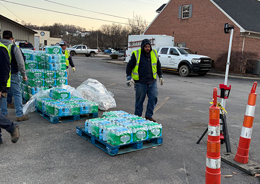 APCo employees pass out water to the community.